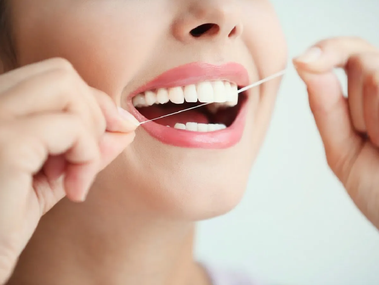 What is the proper way to brush and floss my teeth?